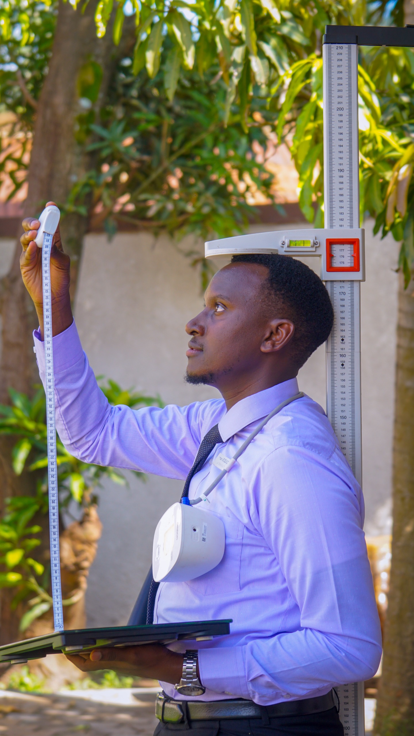 Ivan taking a client's body measurements